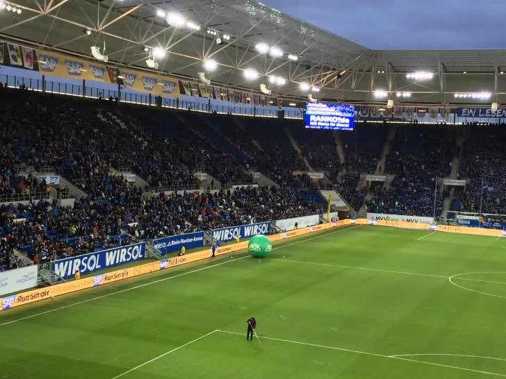 Khán đài với màn hình lớn tại Rhein-Neckar-Arena, nơi từng pha bóng được hiển thị rõ nét.